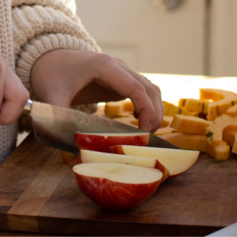 Joy cutting apples on a cutting board